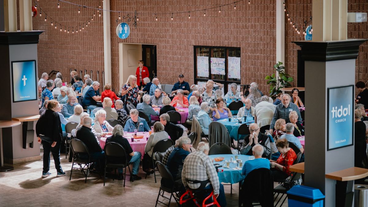 Tidal Seniors gathered around round tables for lunch together after a meeting