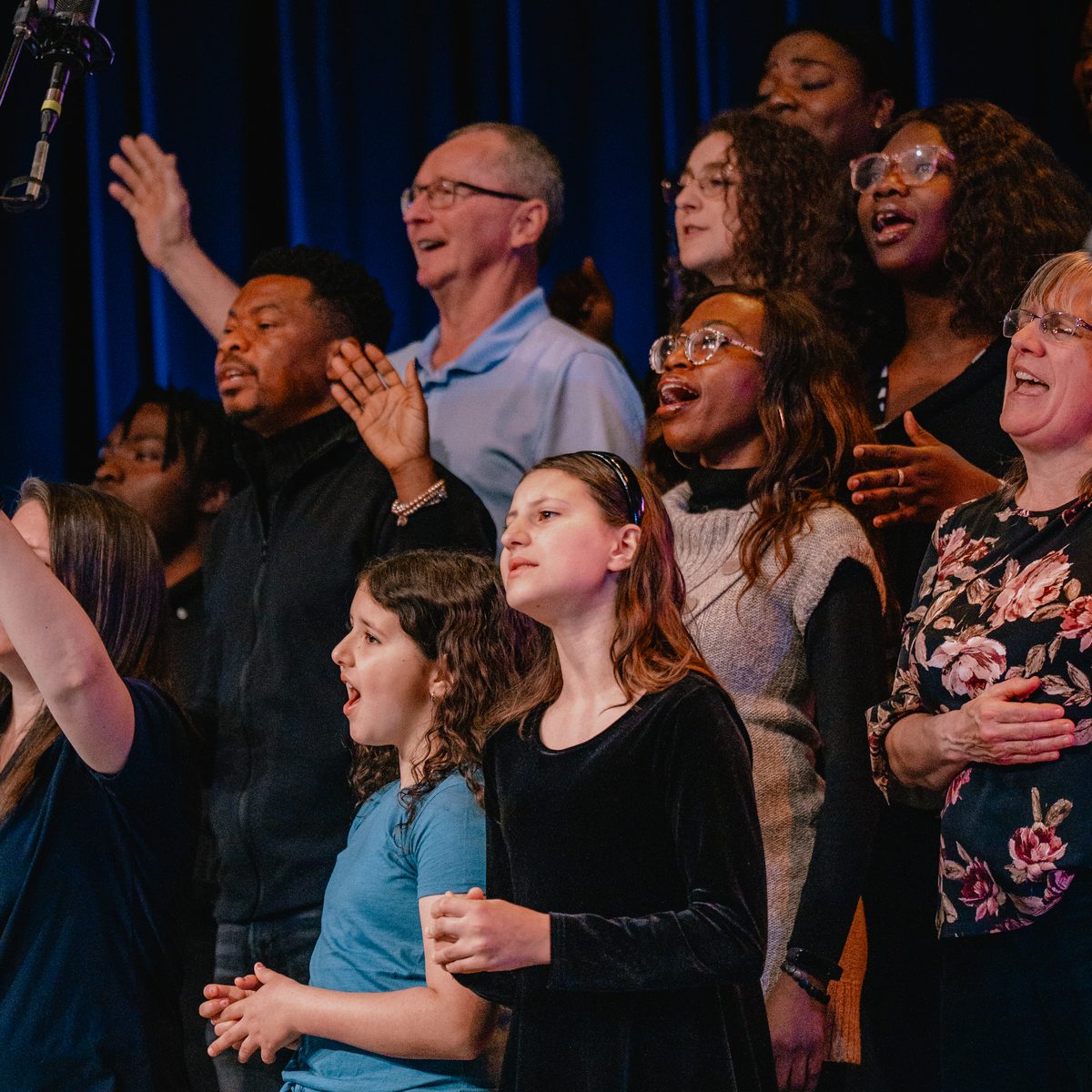 Choir members of all ages singing together during a Sunday service