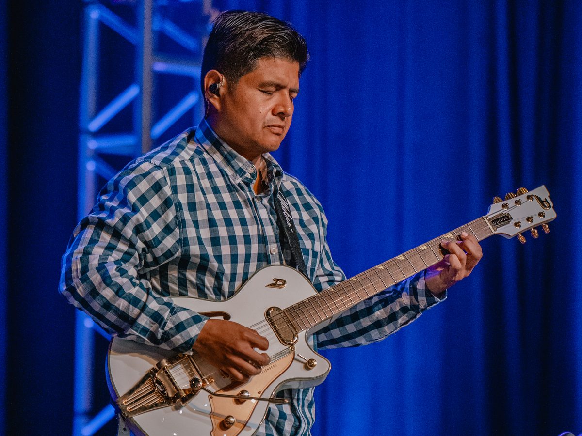 A guitarist playing during a Sunday service