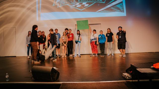 Tidal Youth students and leaders posing on stage together