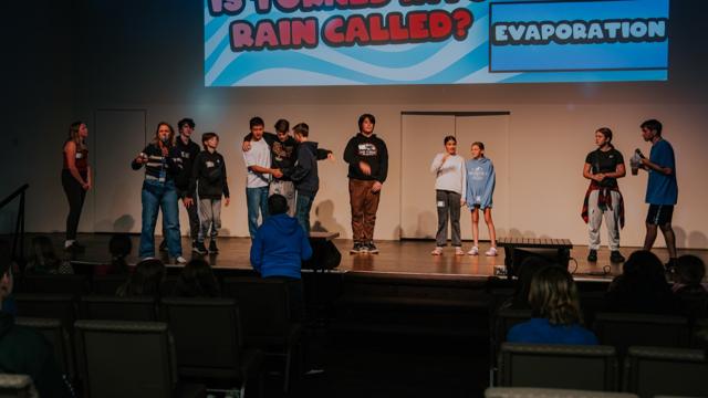 Tidal Youth students playing a trivia game on stage